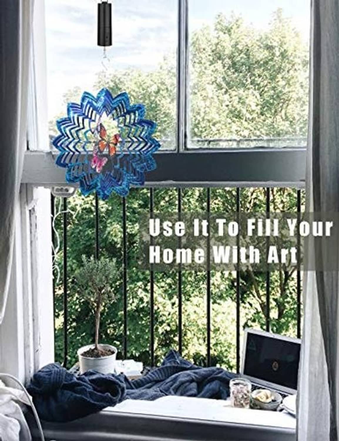 Blue and rainbow rotating flower pinwheel hanging from a window ledge