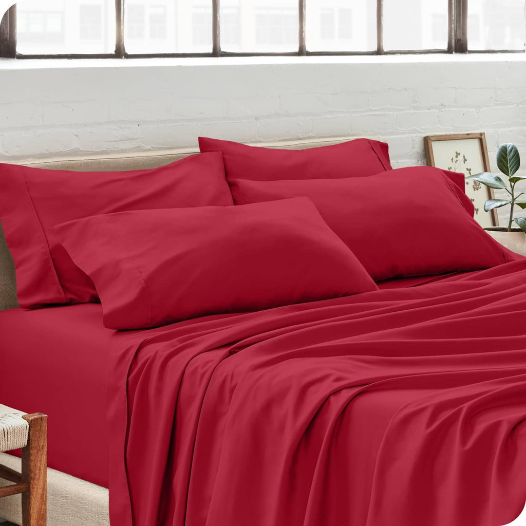 Red microfiber pillowcases on a bed, including two standard-size pillows