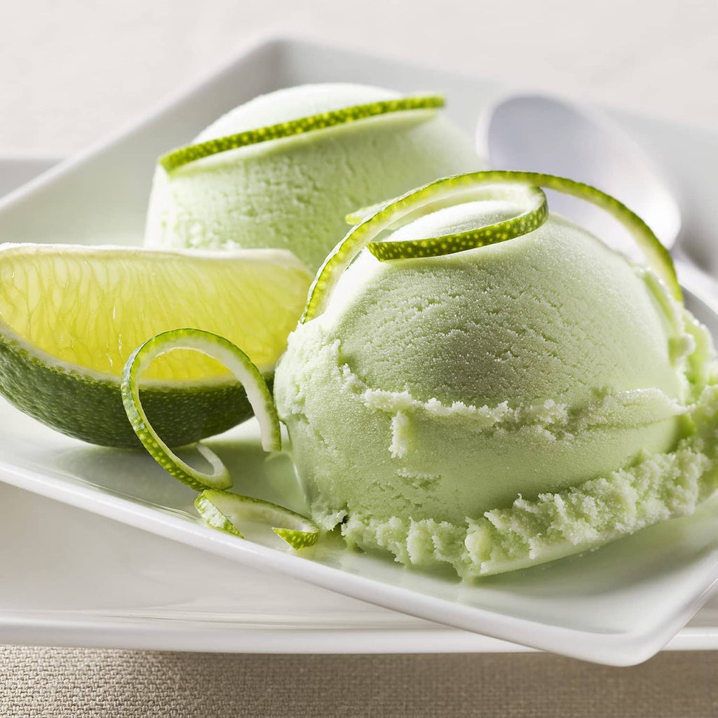 Mounded freeze-dried lime powder with lime slices on a white dish