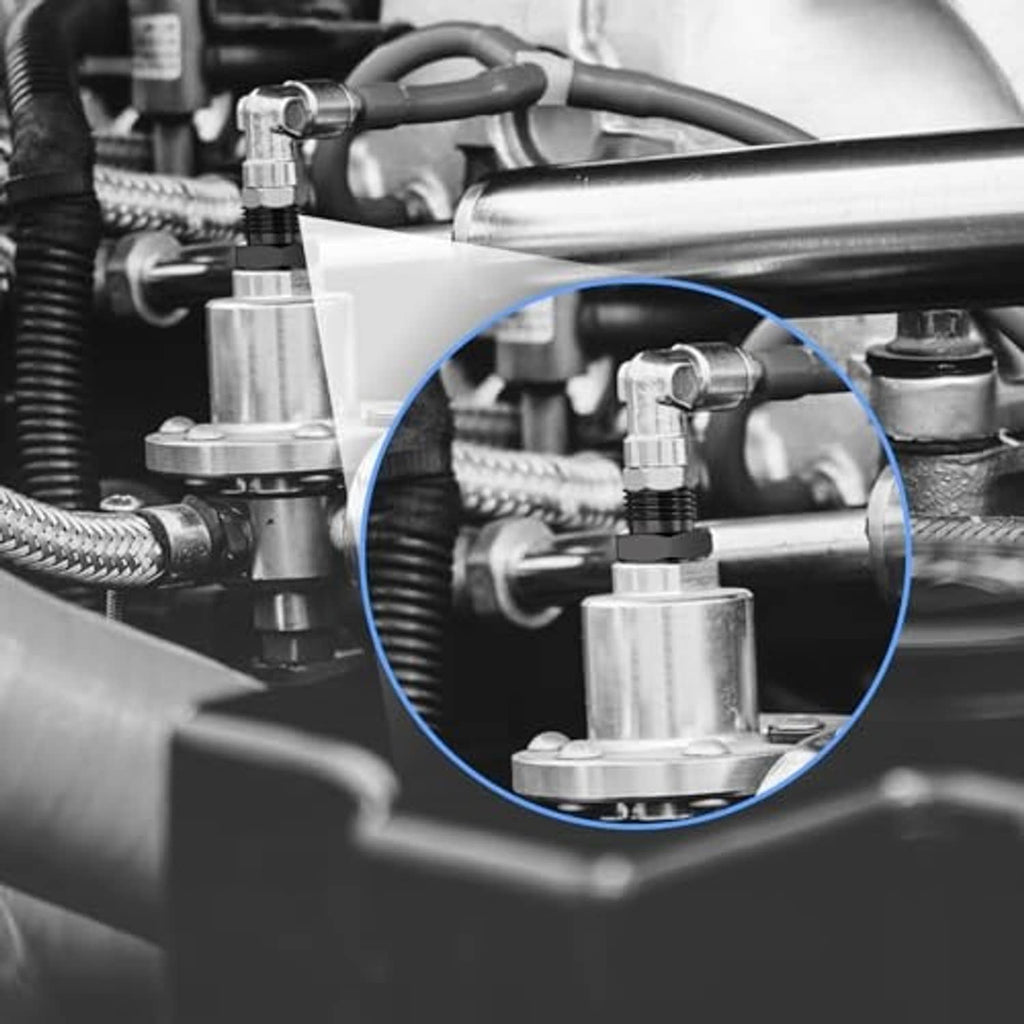 Black NPT fitting adapter connected to hoses and metal fittings, close-up