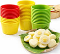 Stacked silicone puto mold cups in red, yellow, and green, with open cup