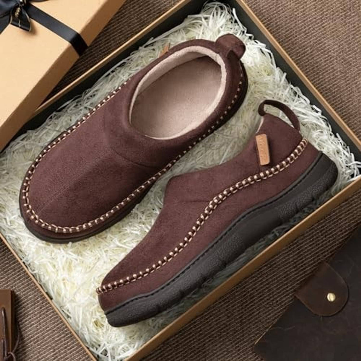 Pair of brown moccasin slippers in gift box with soft light lining and stitched trim