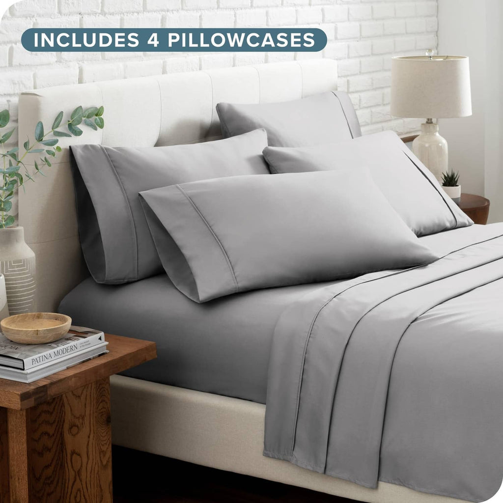 Light grey bed linen set with four pillowcases and coordinating flat and fitted sheets