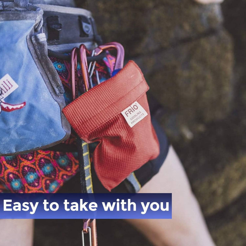 Red FRIO cooling wallet case with fabric strap detail, shown close-up on a bag