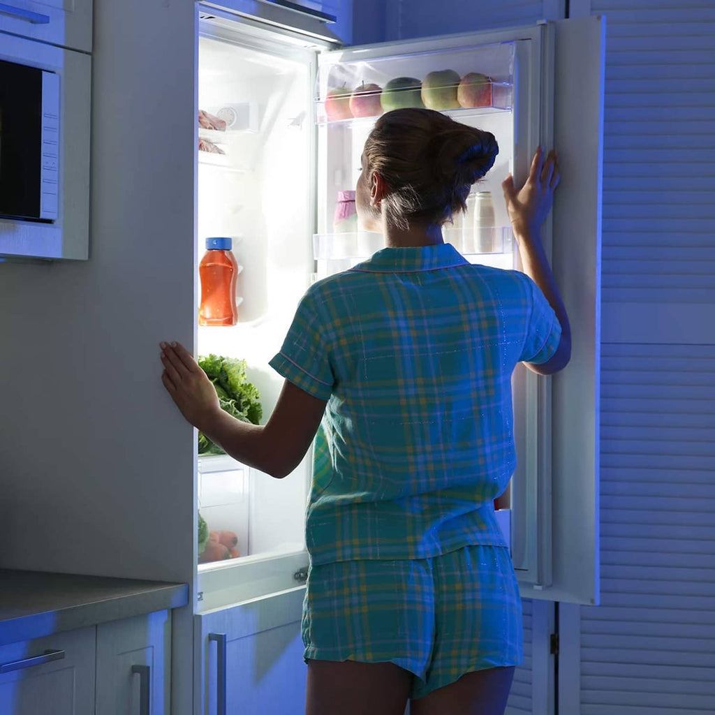 Open refrigerator door with bright LED interior lighting from the light bulbs