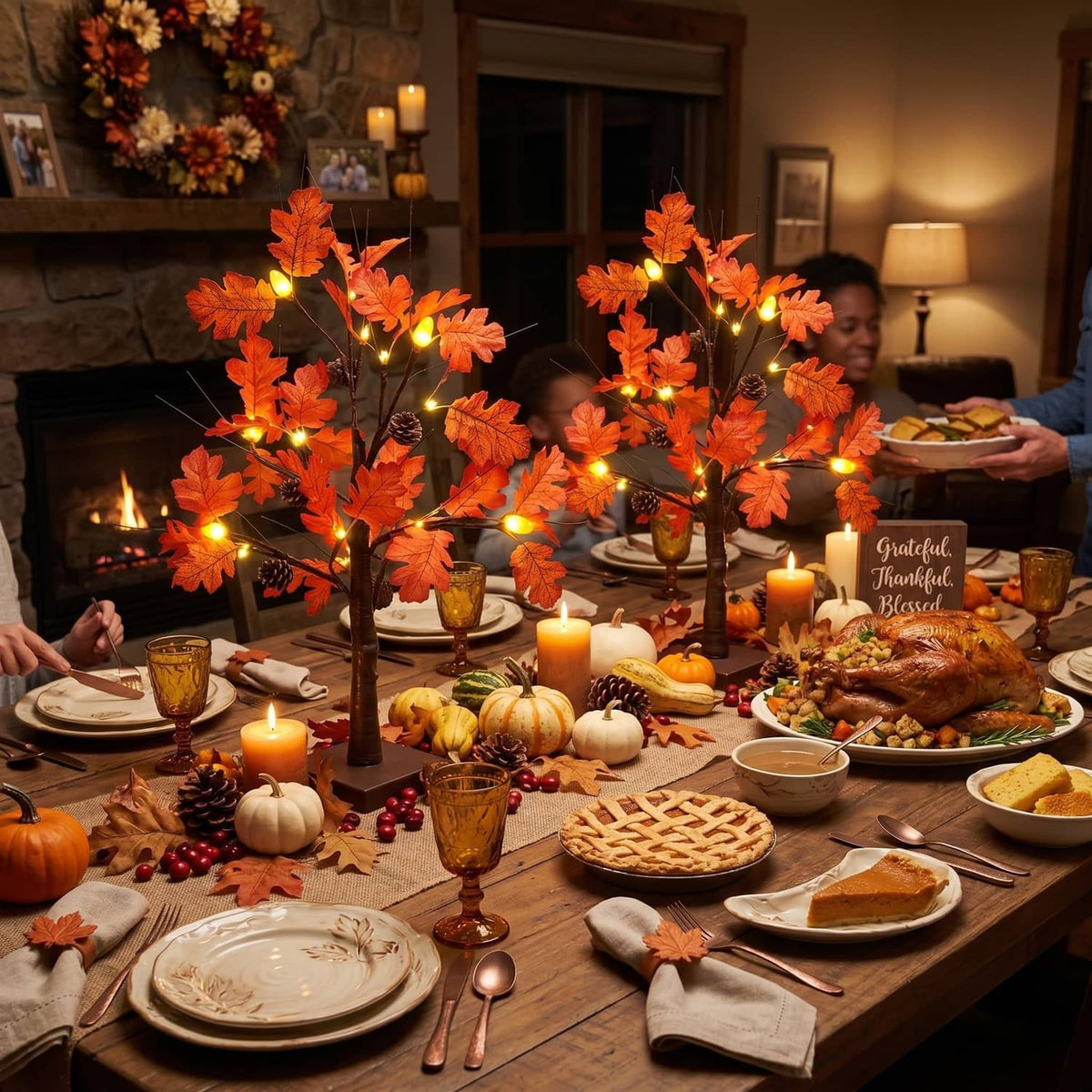 Lighted fall acorn tree decorations with orange leaf lights in an autumn dinner scene