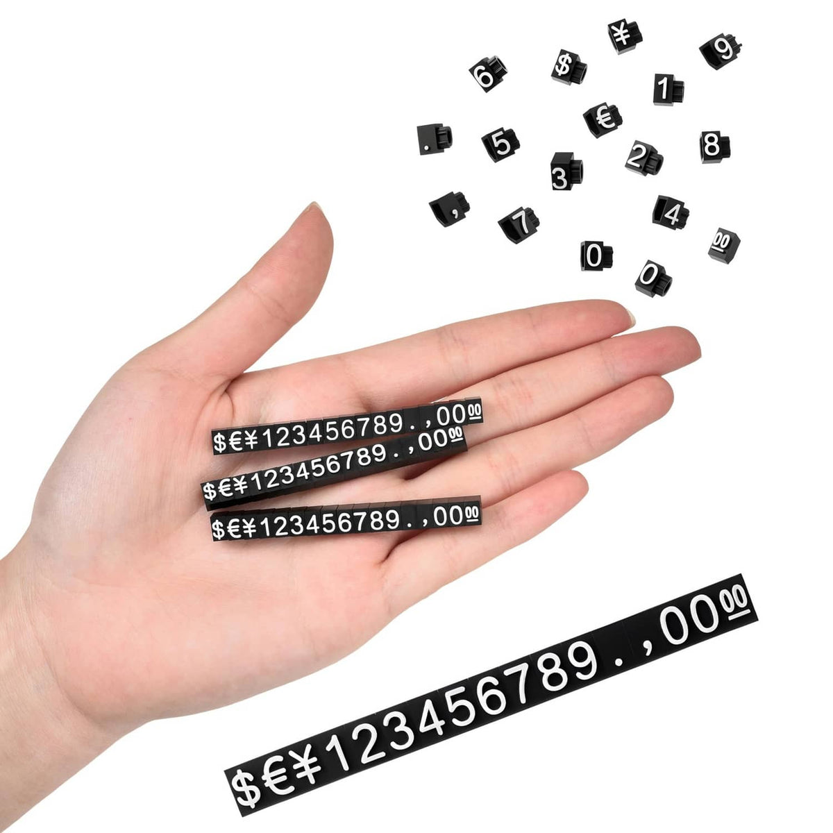 Hand holding black price display tag strip and small number cubes with $€¥ amounts