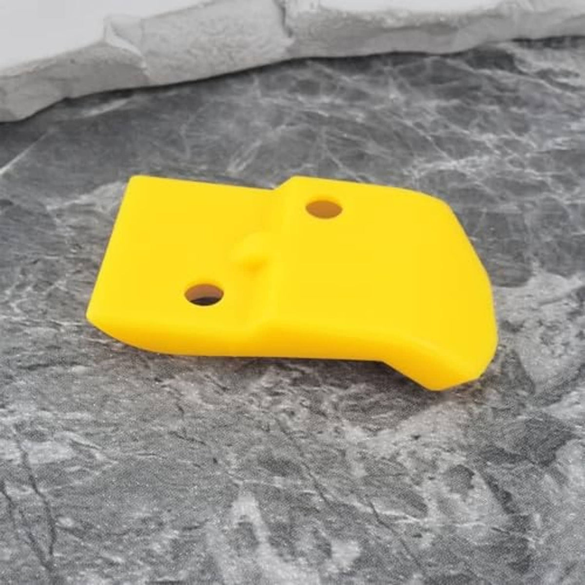 Yellow plastic tire changer head insert with two holes, single piece
