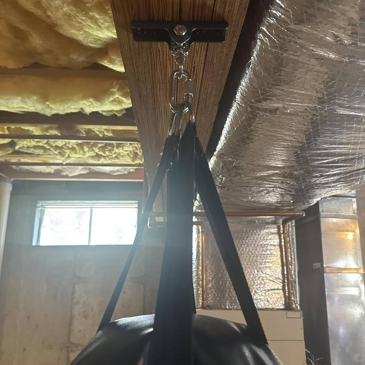Matte black hanger bracket with chain and hanging hook from ceiling beam