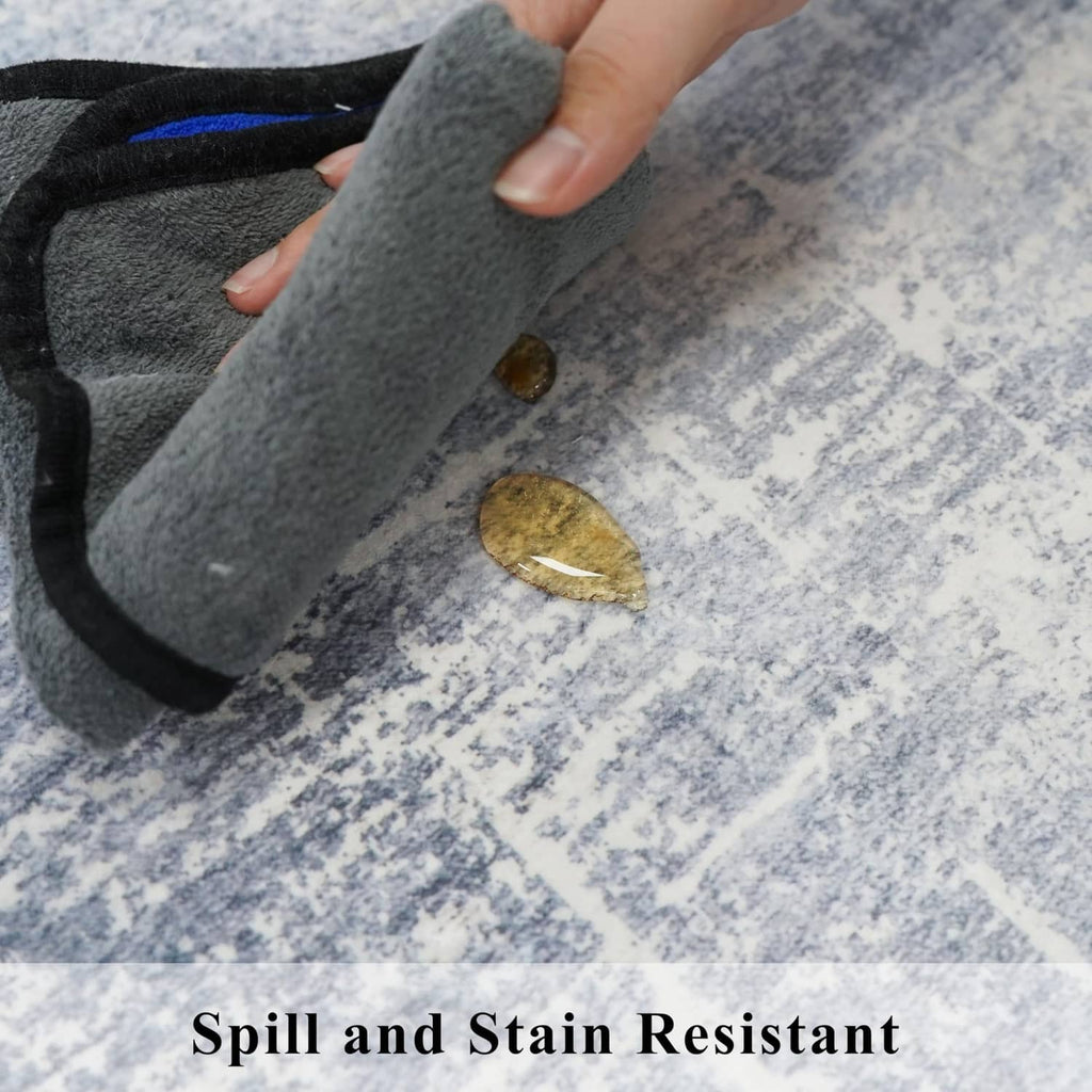 Blue and ivory rug corner detail with a hand pressing the soft, textured fabric.