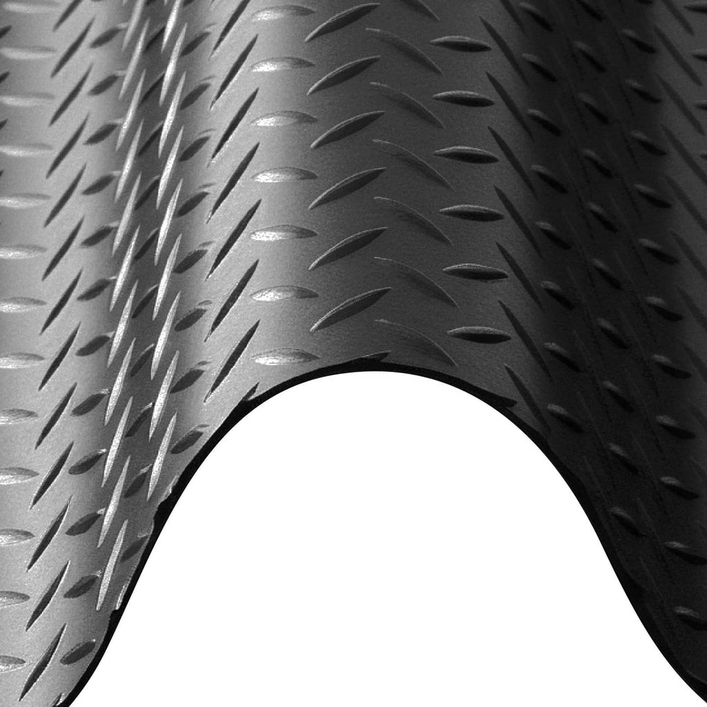 Dark rubber diamond-plate garage mat, raised traction texture close-up