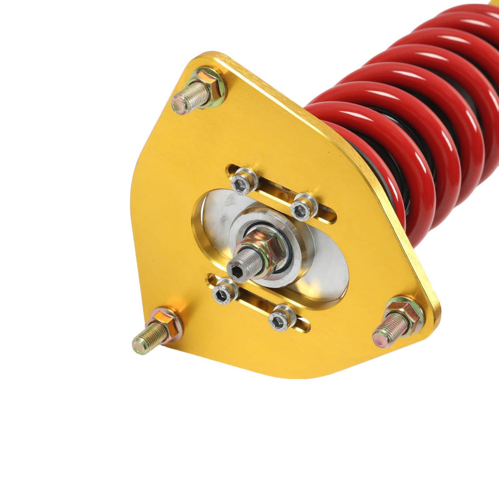Coilover strut top mount with red spring and silver bearing hardware on a gold bracket