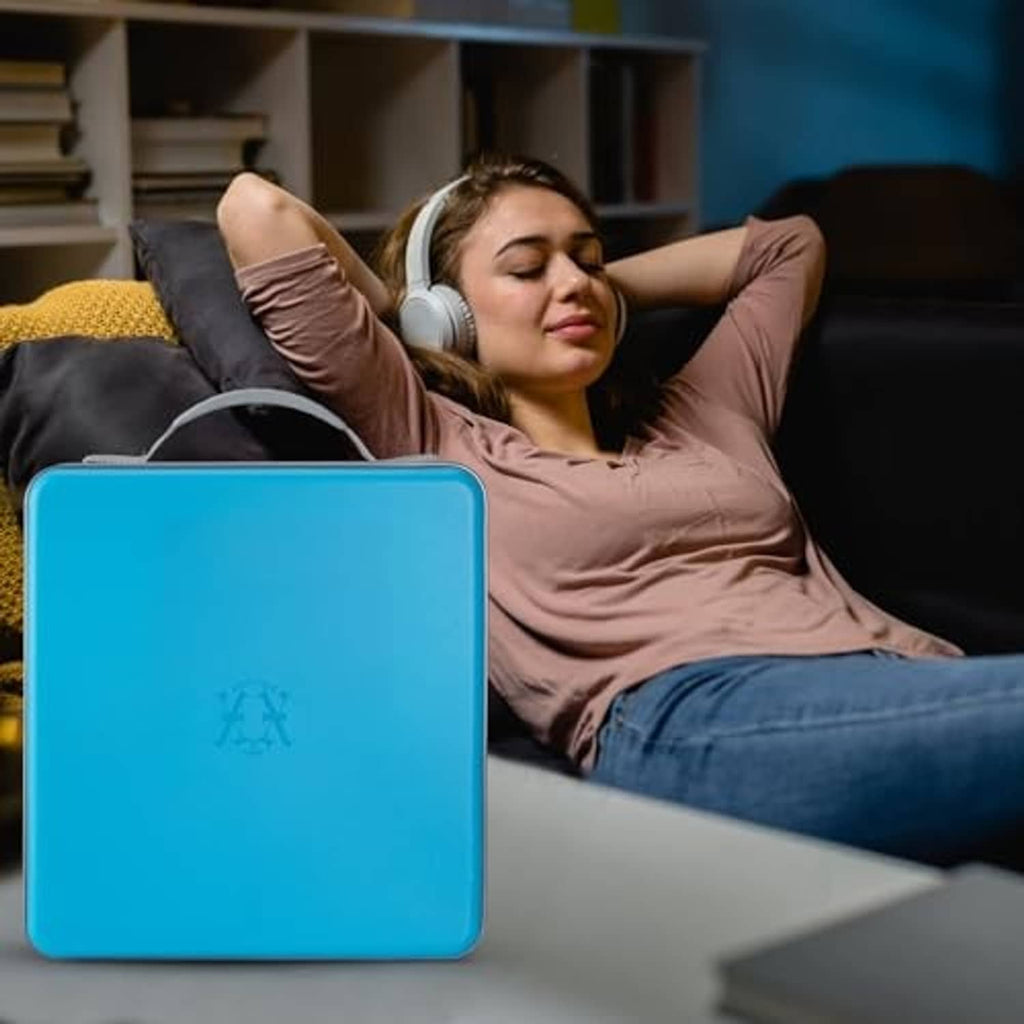 Sky blue hard plastic CD case organizer on floor near seated person, with carry handle.