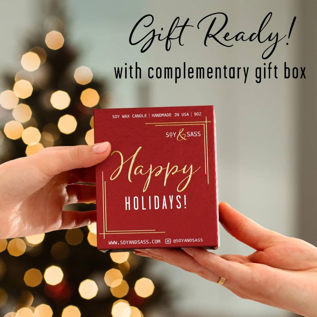 Hands holding a red holiday gift card with a complementary gift box