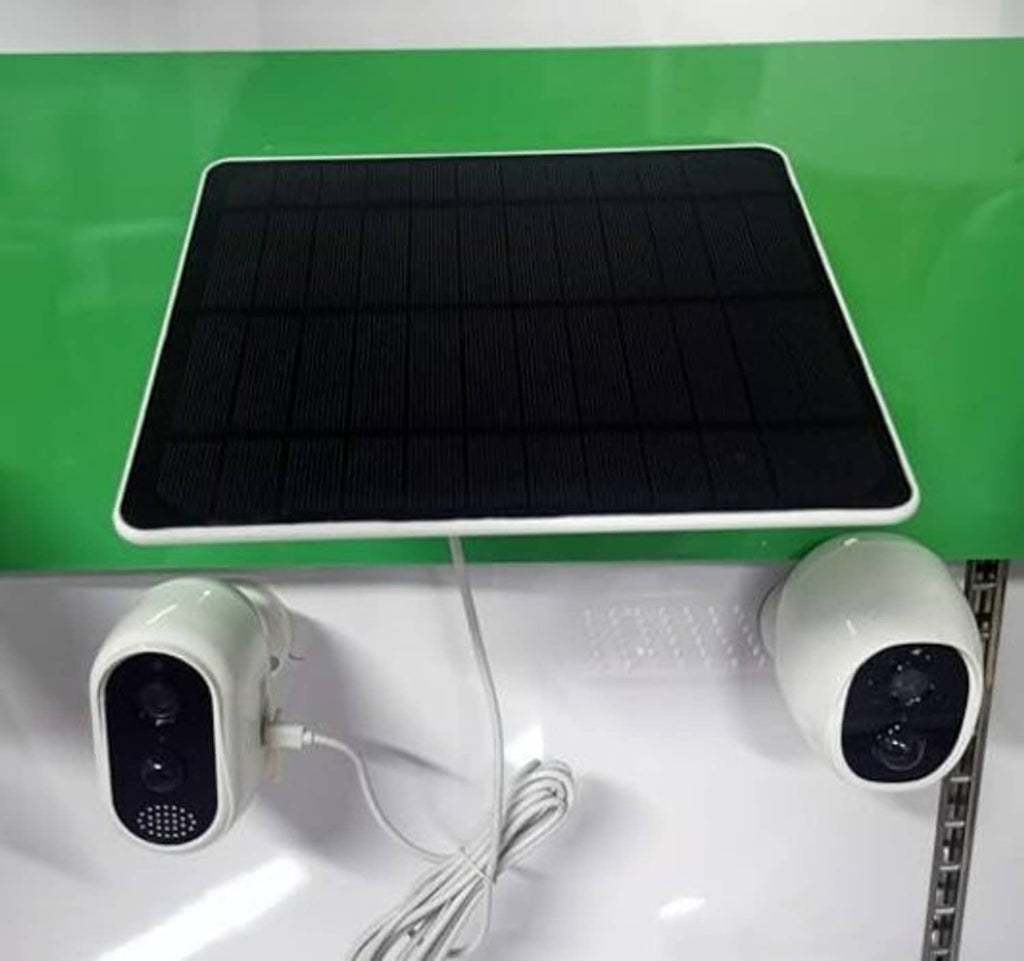 Security camera pair with a dark solar panel on a white mount