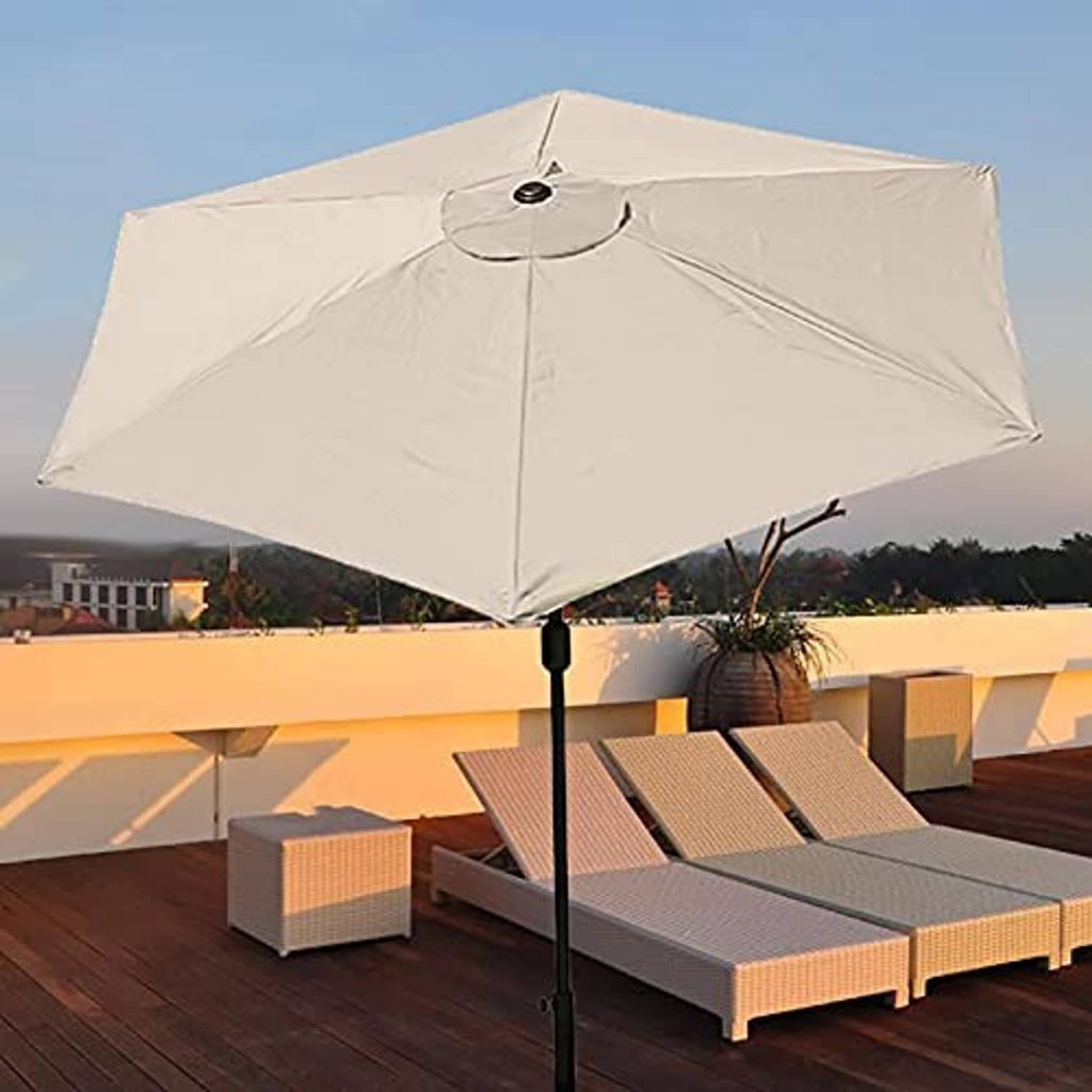 Light cream patio umbrella canopy installed over an outdoor table and seating