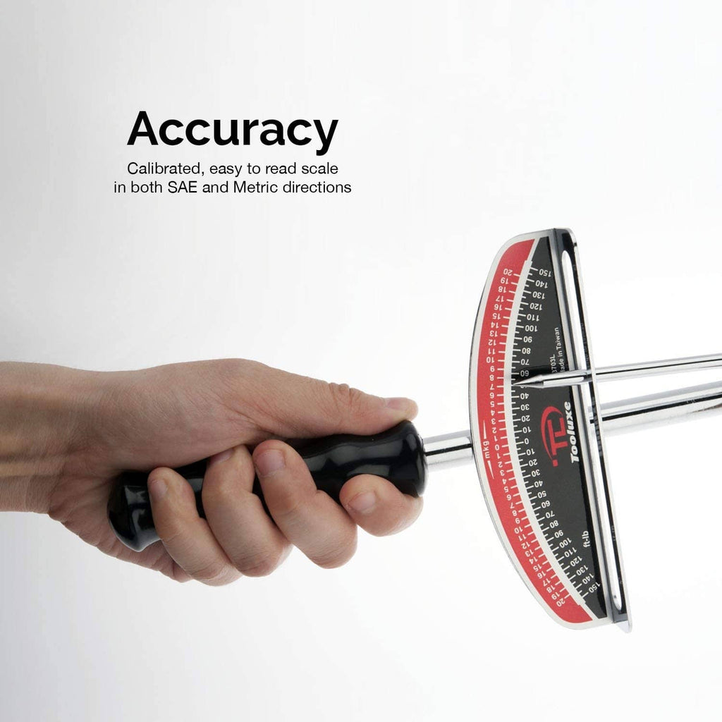Torque wrench held in hand with red and black dual scale for SAE and metric