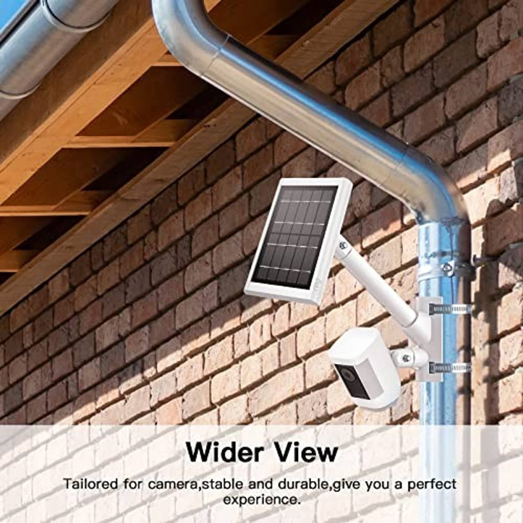 White pole mounting bracket with camera holder near brick wall and metal downspout