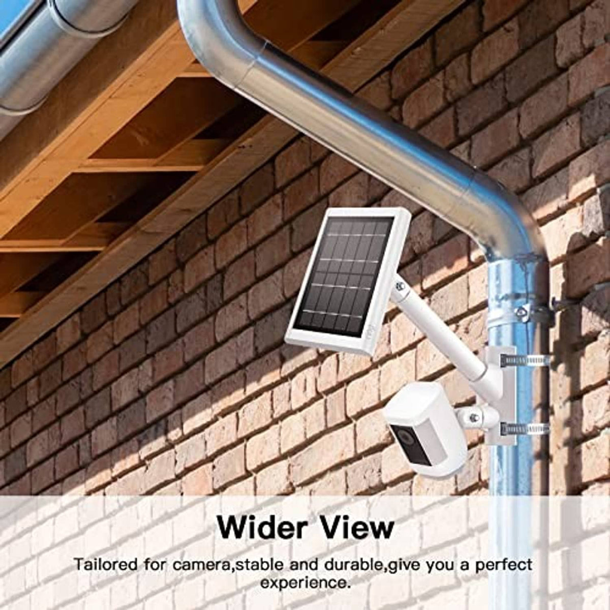 White pole mounting bracket with camera holder near brick wall and metal downspout