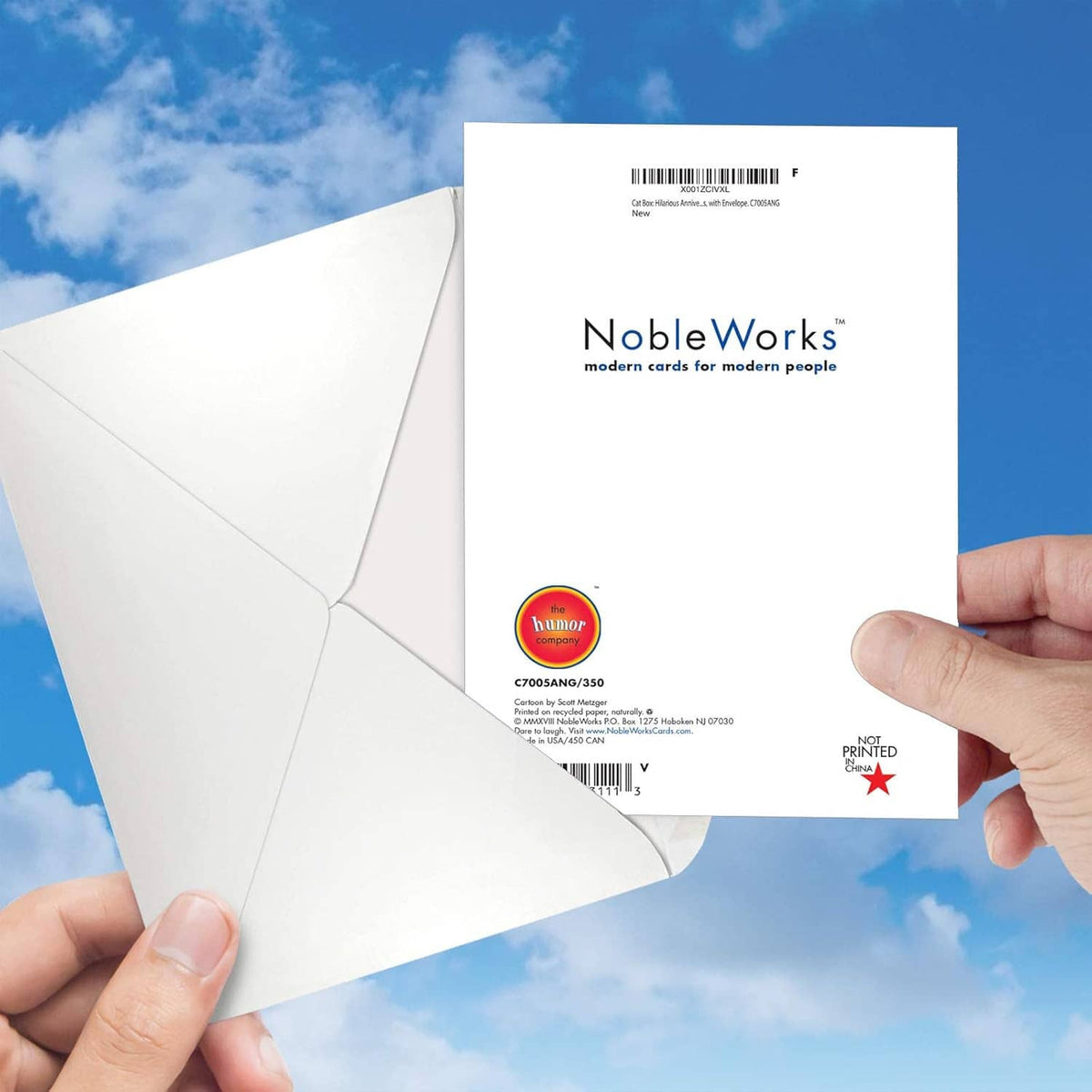 White envelope back with NobleWorks logo, barcode, and shipping details held in hand