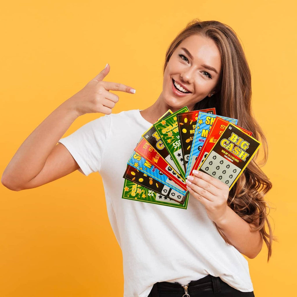 Smiling woman holding colorful scratch-off lottery tickets with several prize panels visible