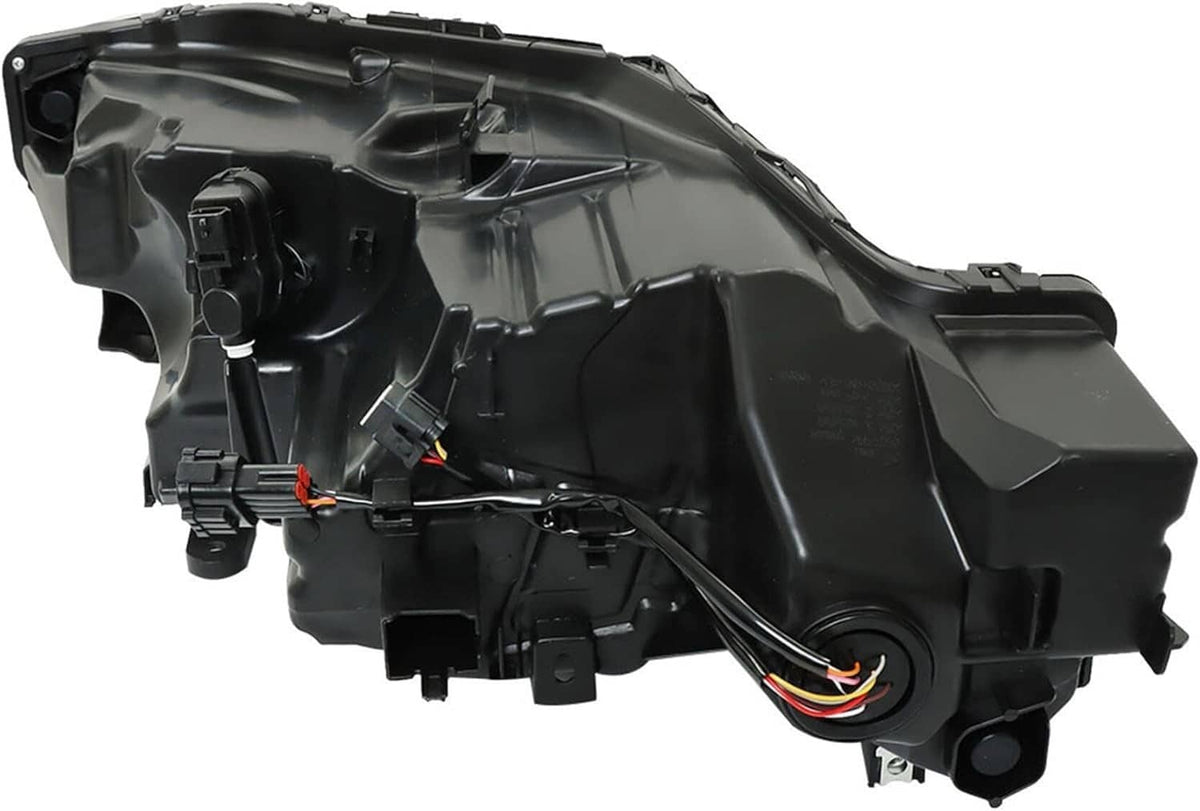 Rear view of black headlight housing with wiring harness and mounting points.