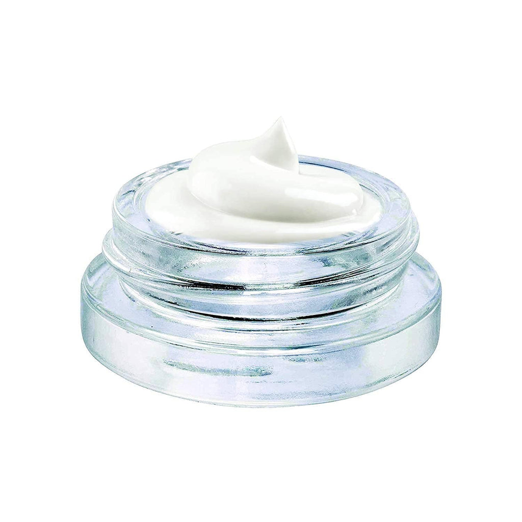 Clear glass jar with white cream inside and open lid
