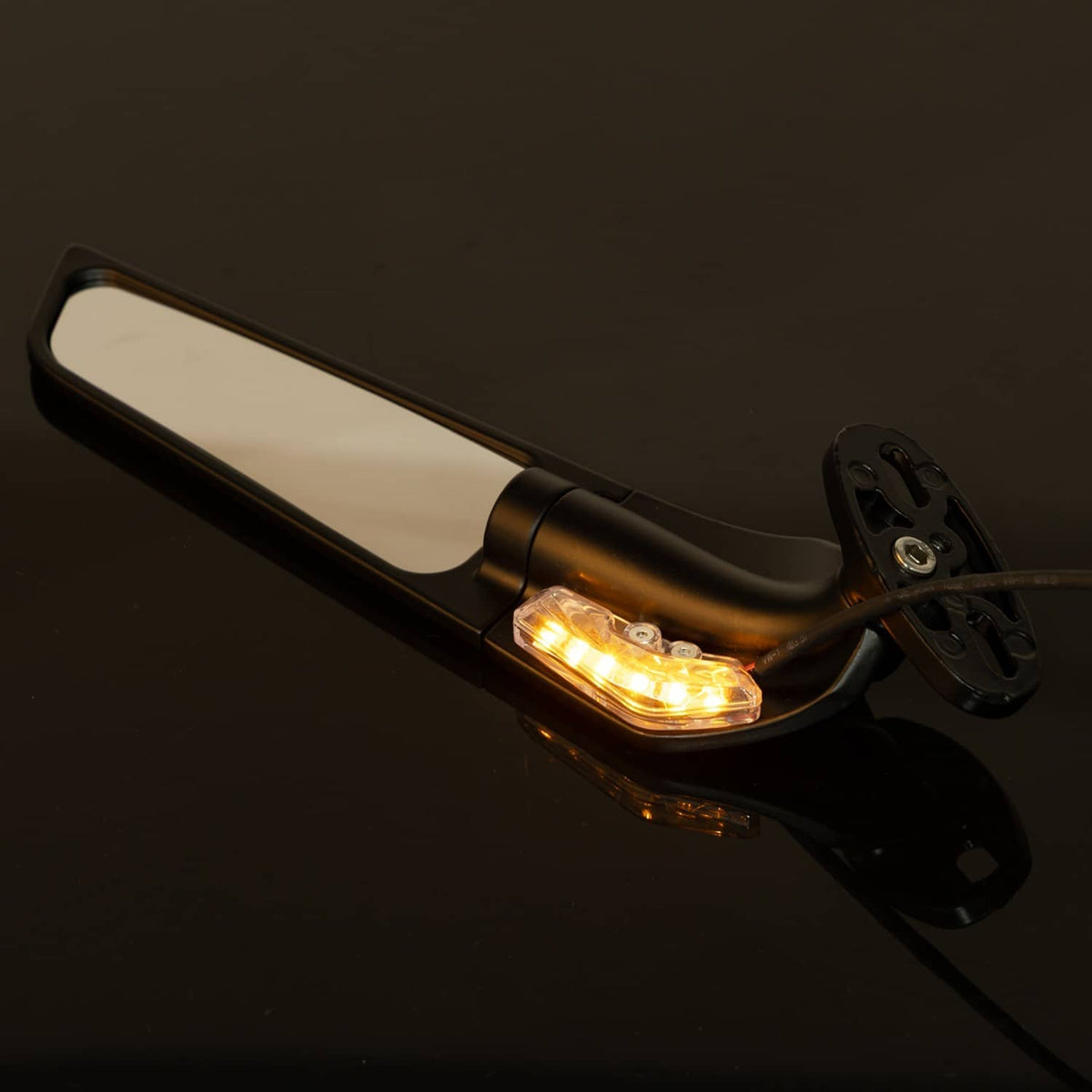 Black rearview wing mirror with glowing amber LED turn signal through clear lens