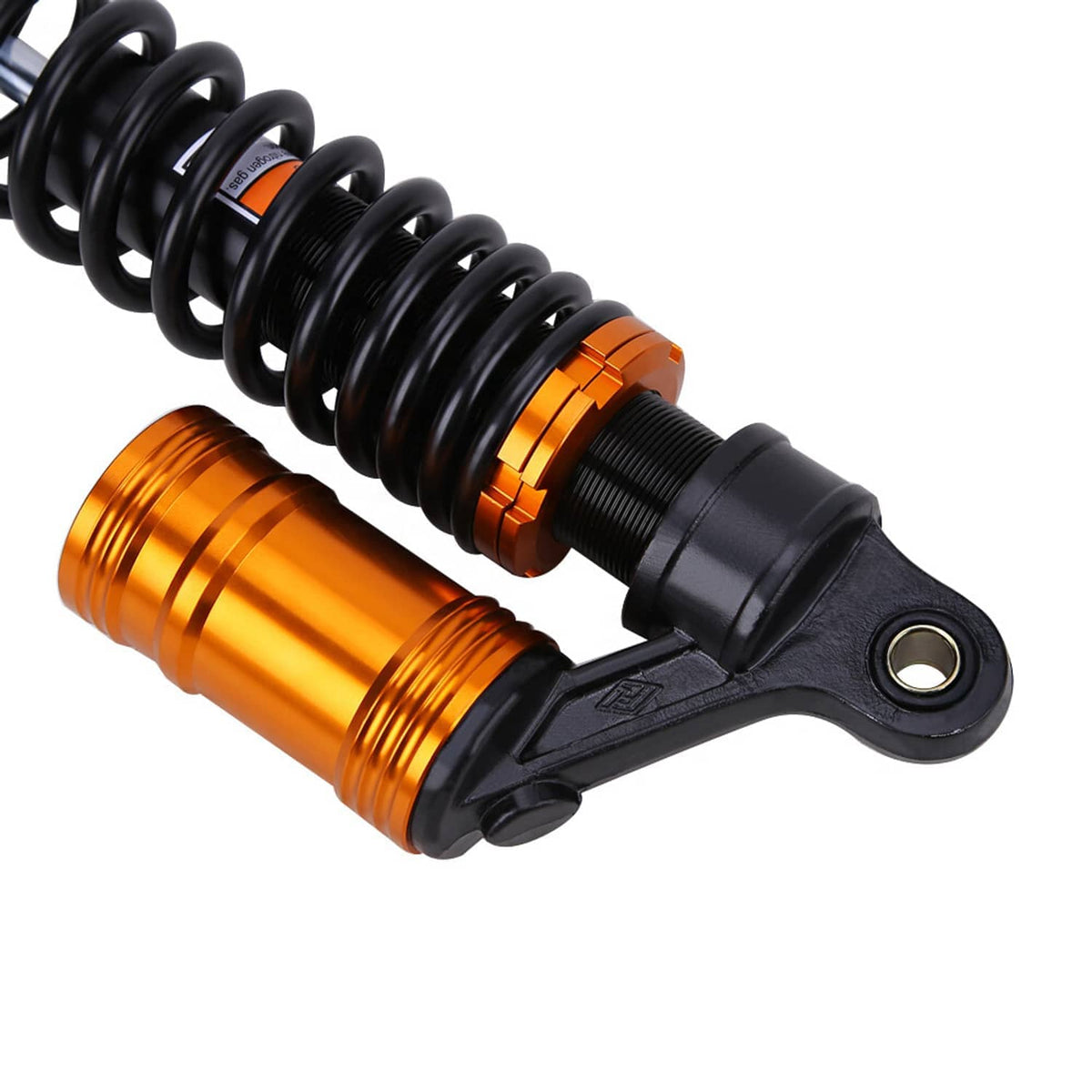 Front air shock absorber detail with black spring, orange reservoir, and mounting bracket