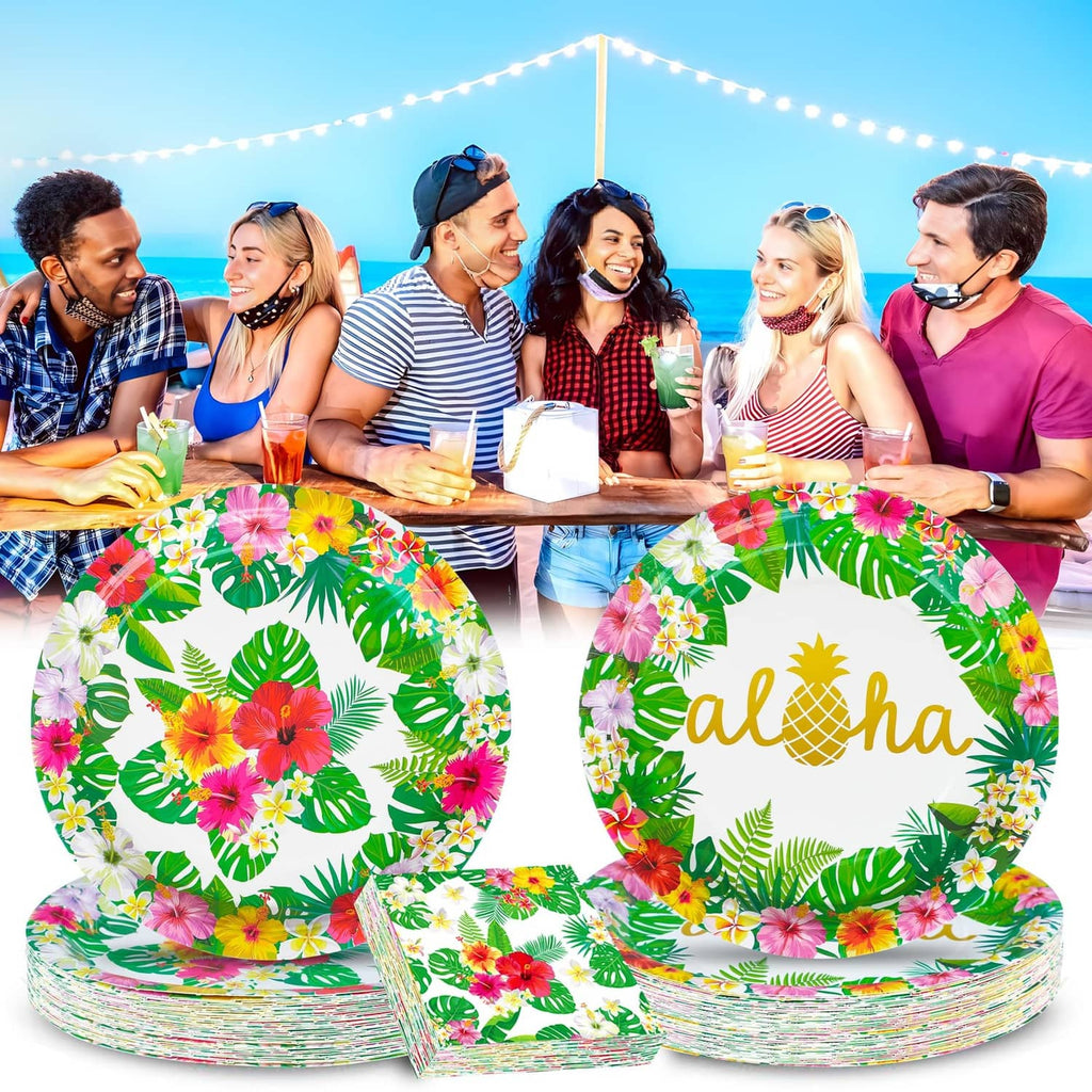 Tropical luau paper plates on party table, green leaves and flowers with 'aloha' text