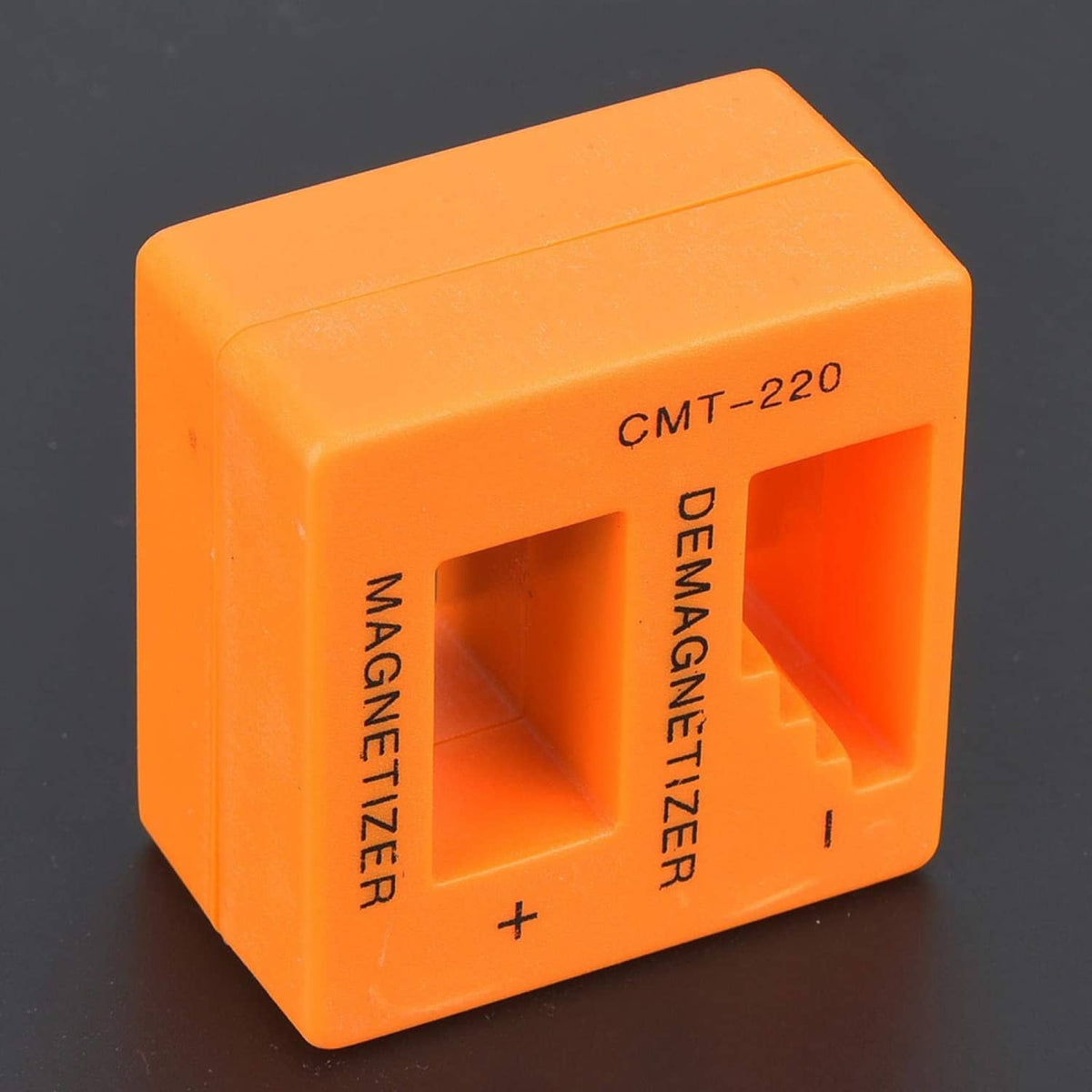 Orange demagnetizer/magnetizer cube with CMT-220 label and tool insertion channel