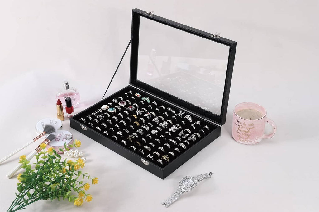 Black ring case organizer with open clear lid and ring slots in the tray