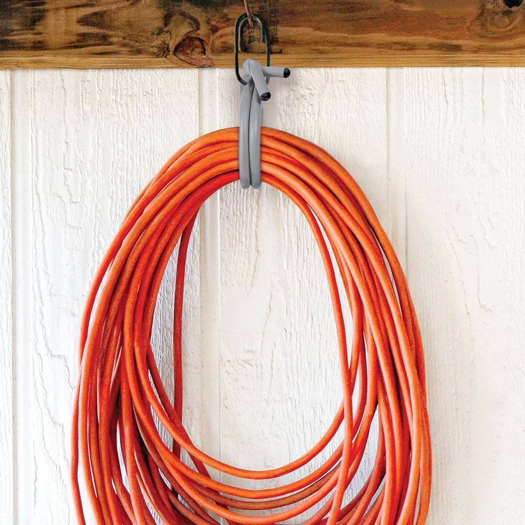 Orange reusable tie straps looped and hanging from a metal hook