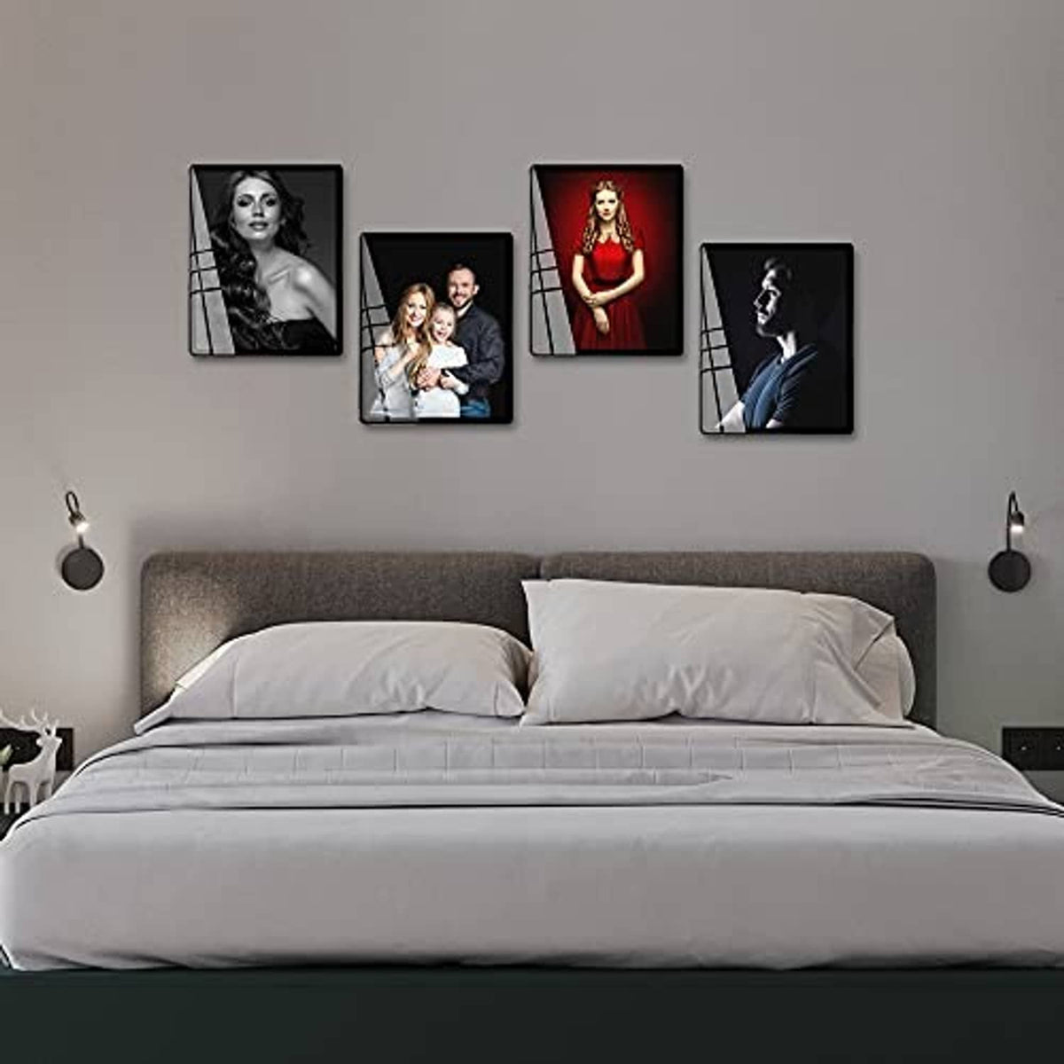 White 8x10 picture frames arranged on wall above bed with portrait photos.