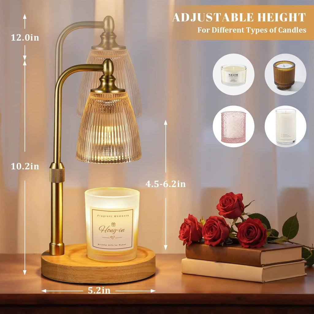 Adjustable brass candle warmer with clear bell glass and jar candle on wooden stand