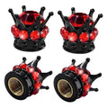 Four-piece set of black tire valve stem caps with red jeweled crown ornaments