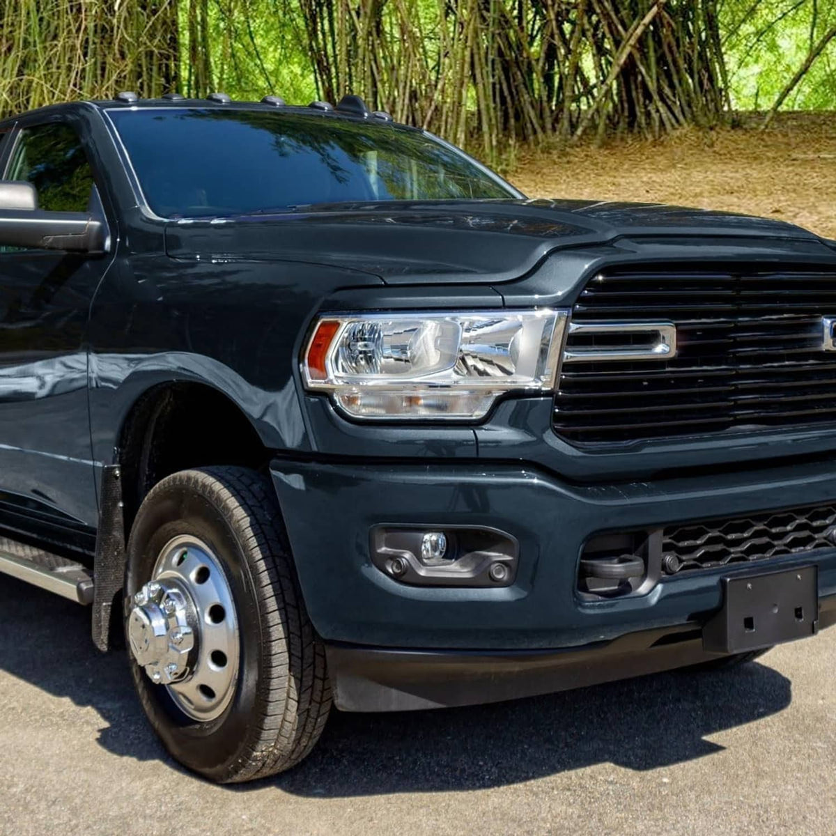 Right halogen chrome headlight installed on a dark pickup truck front