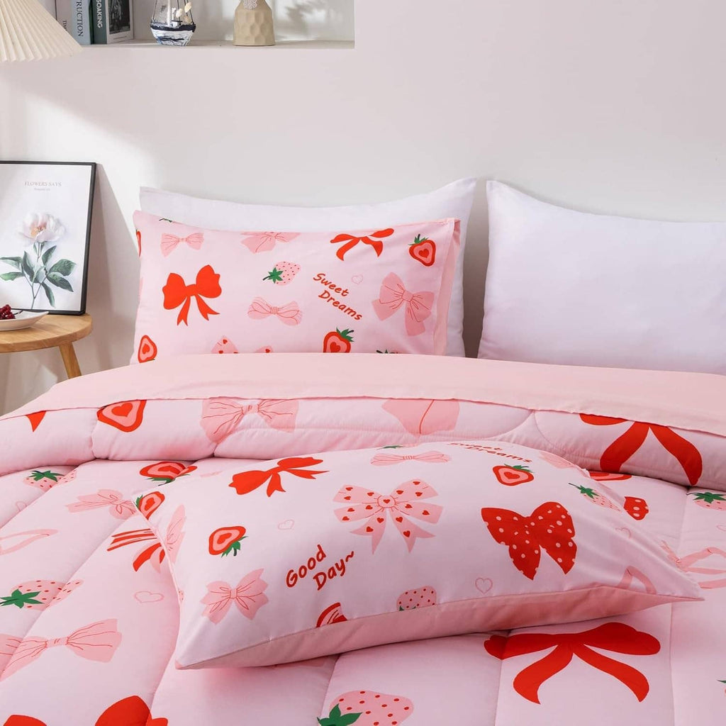 Close-up of pink comforter set with bow print and matching pillowcase