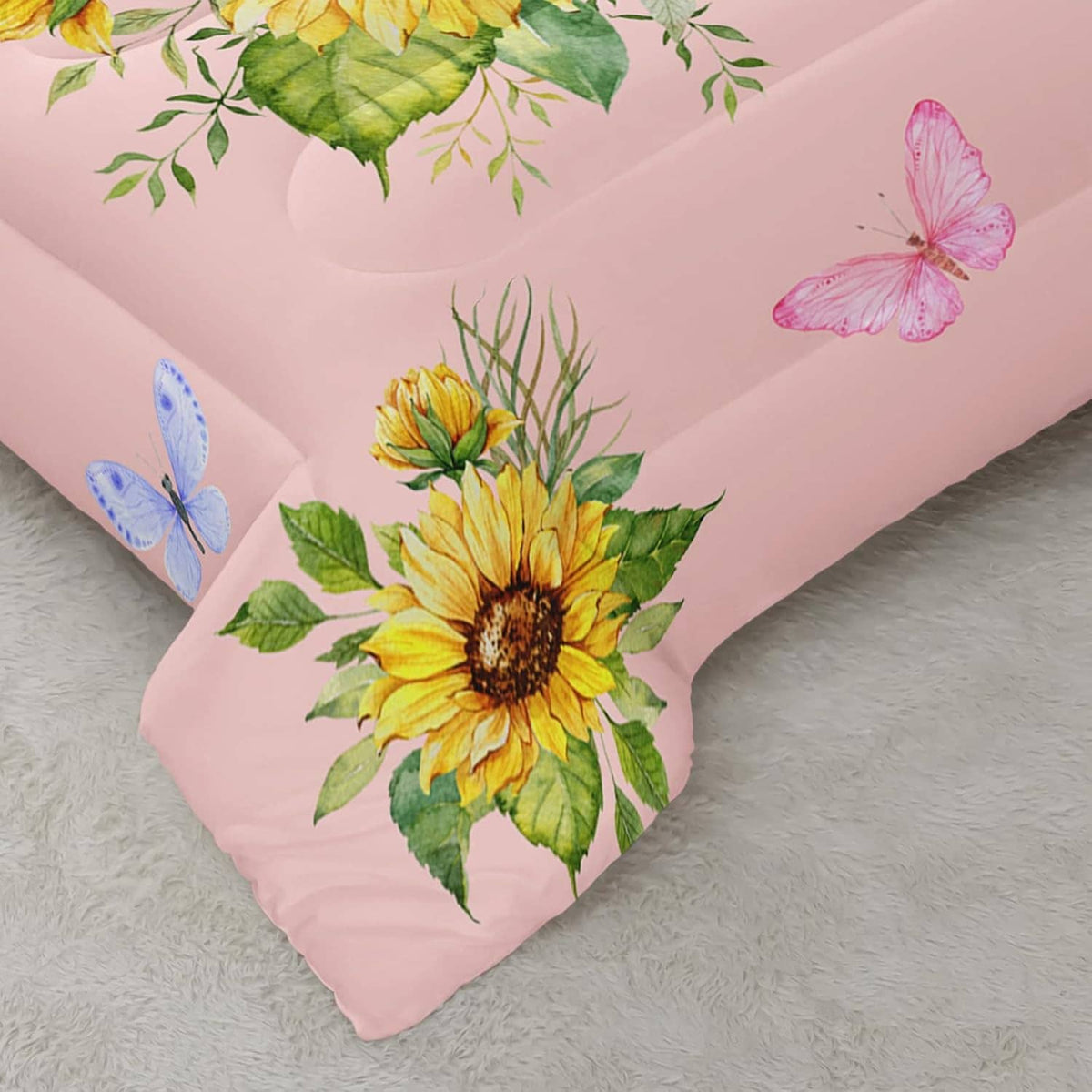 Pink comforter corner with large sunflower print and butterfly graphic