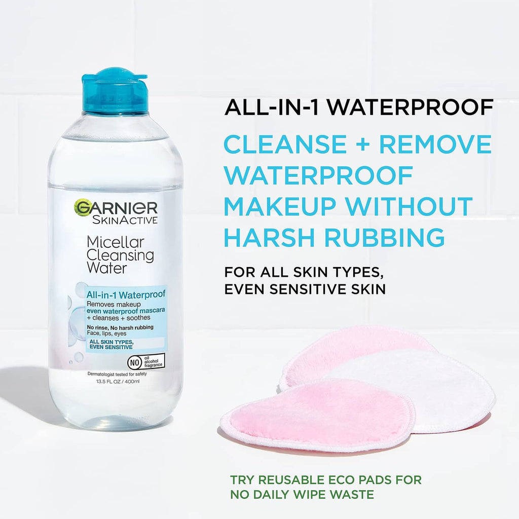 Micellar cleansing water bottle with blue cap and pink reusable cleansing pads.