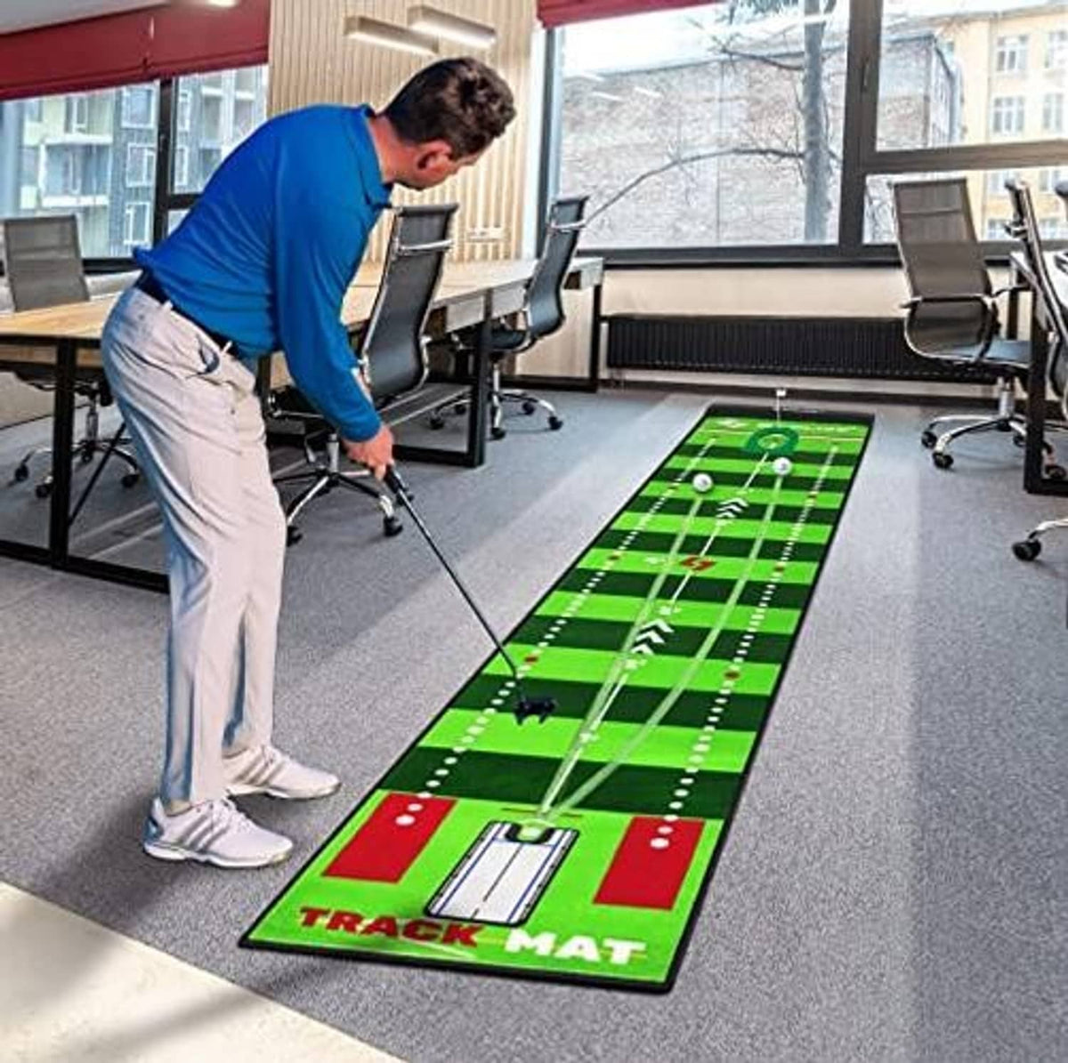 Green putting practice mat on floor in room with golfer practicing stroke and ball path guides