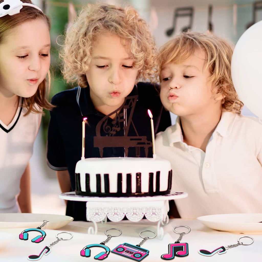 Music-themed keychain charms on metal keyrings with note, headphones, and boombox icons