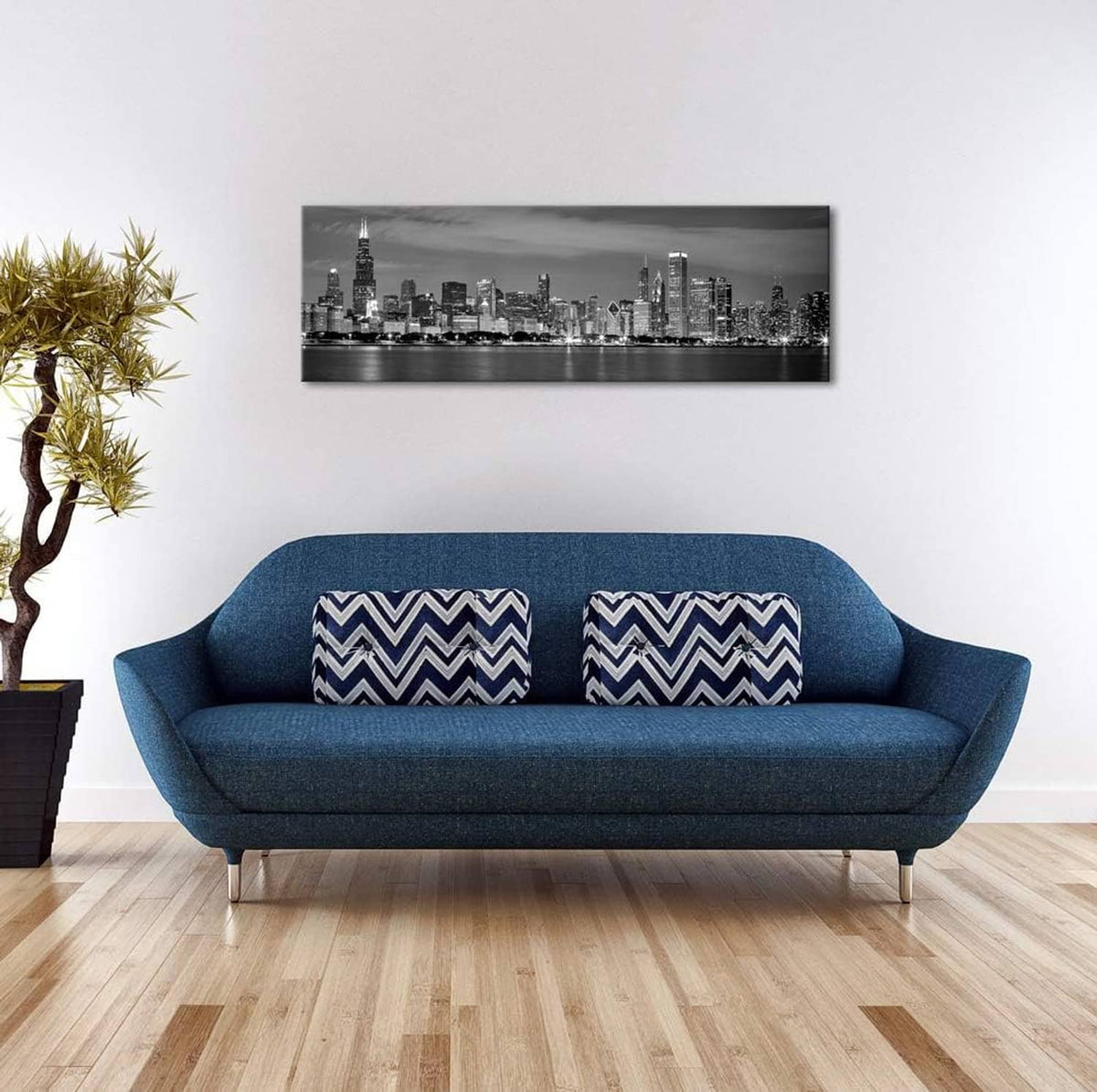 Black and white Chicago skyline canvas print on a white wall above a blue sofa
