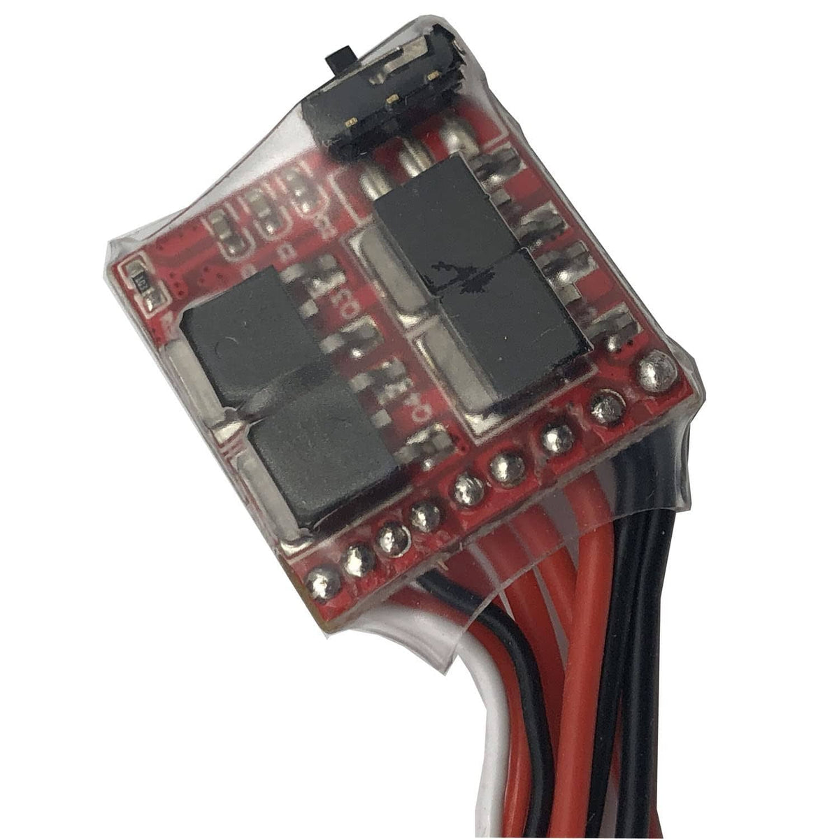 Brushed RC ESC control board with black chips and red terminal pins