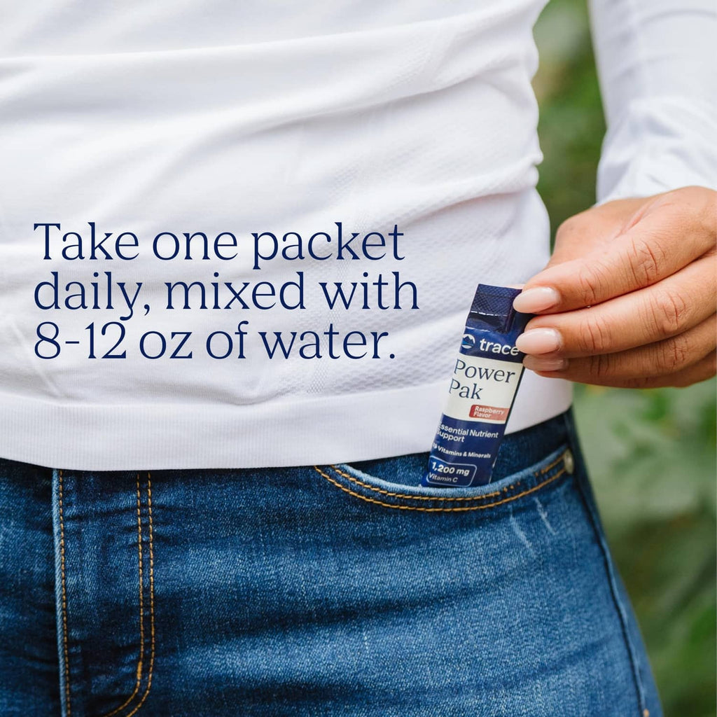 Blue Power Pak electrolyte powder packet, held by hand near jeans