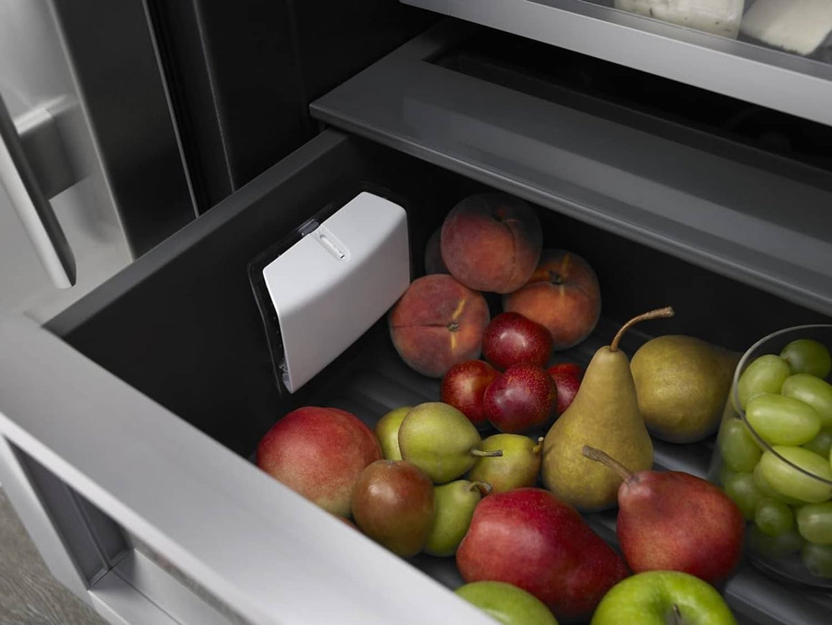 White produce preserver in refrigerator crisper drawer with mixed fruit