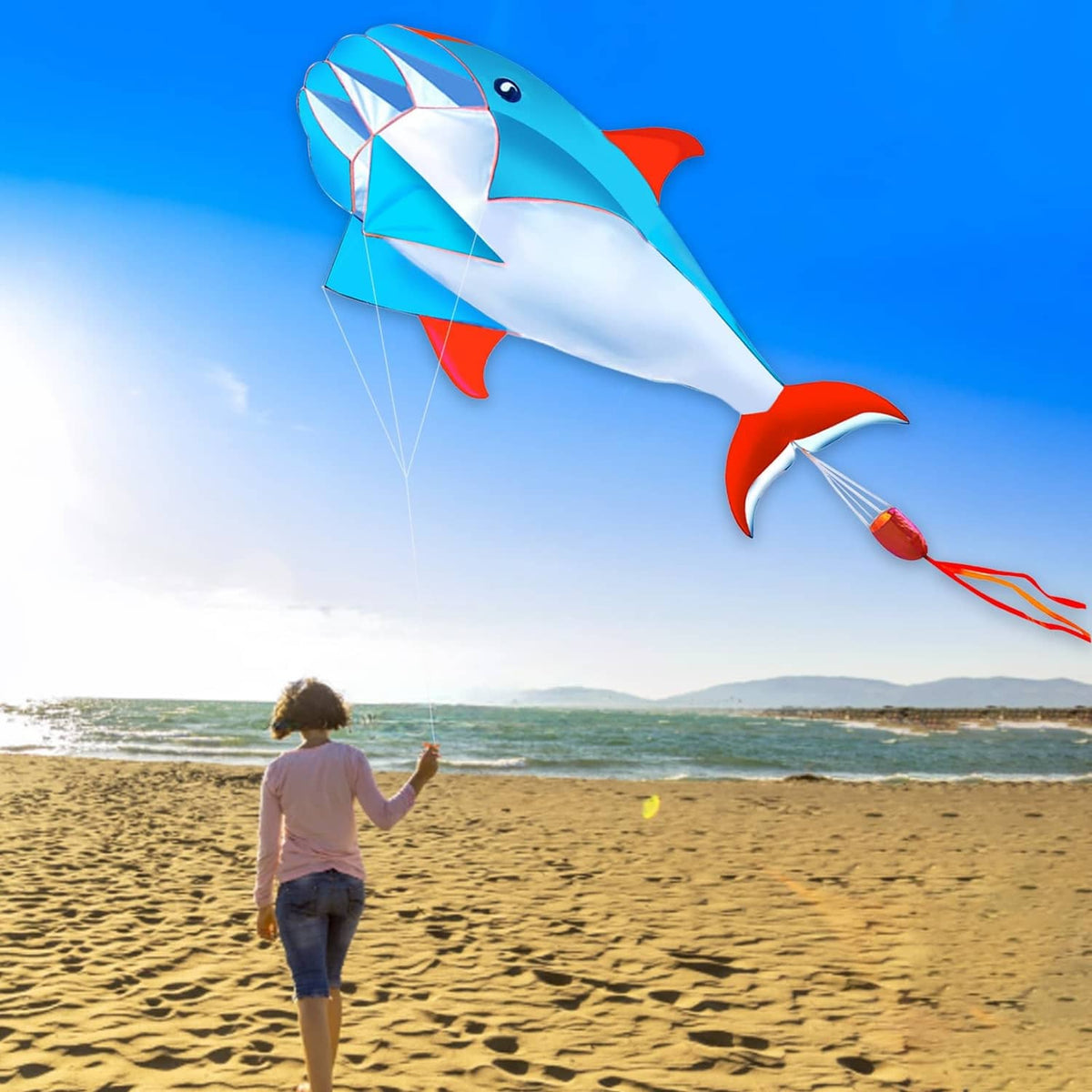 Blue 3D dolphin kite with white belly and red fins, diamond sail and long flying line