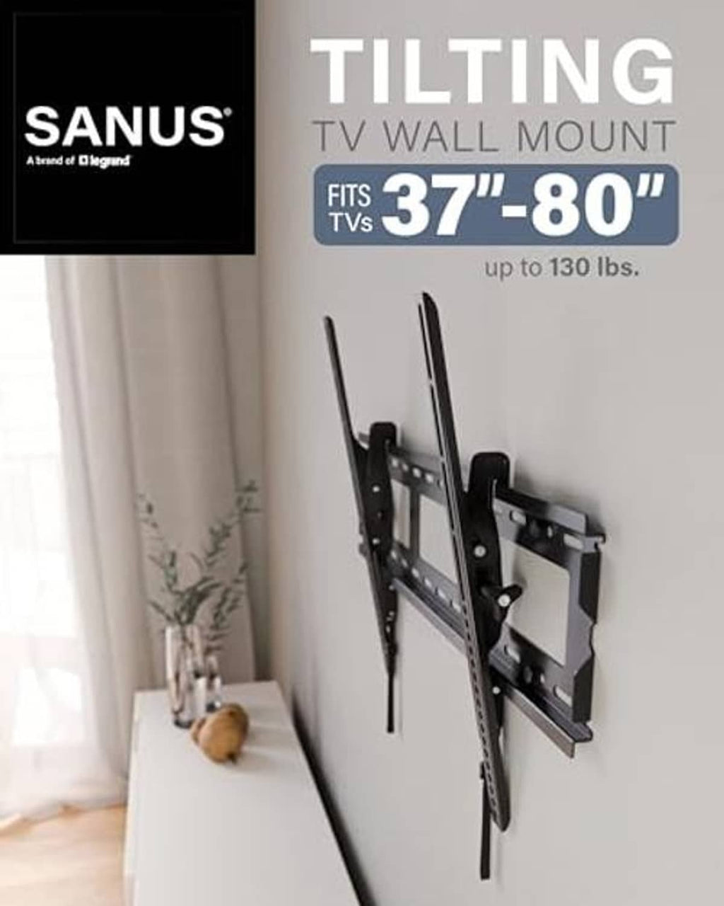 Black TV wall mount bracket installed on a wall with a slim tilting plate
