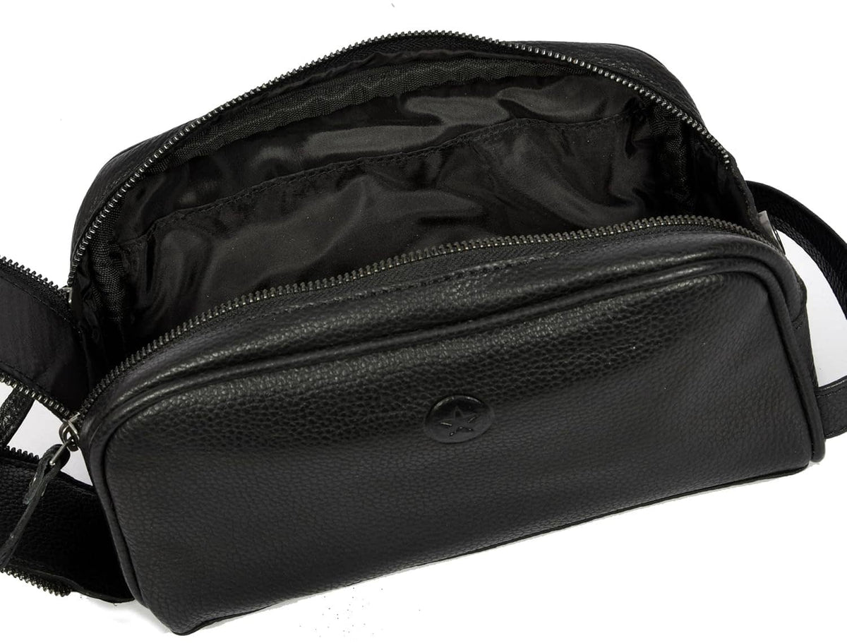 Black leather toiletry pouch open with visible inner pockets and zipper tracks
