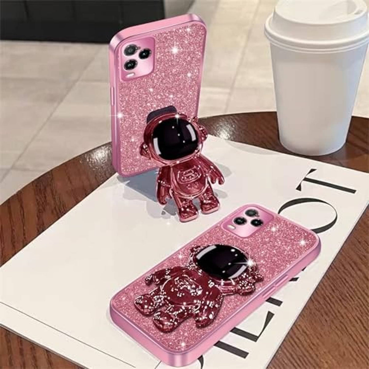 Rose gold glitter phone case with astronaut kickstand figurine, rear camera cutouts